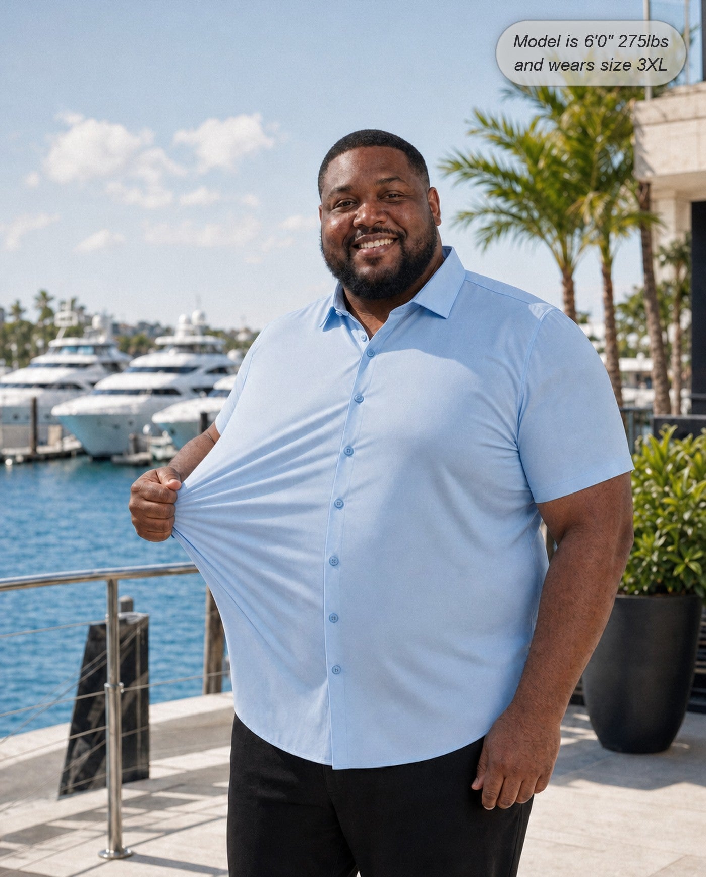 Sovereign stretch dress shirt in sky blue, short sleeve, stretching the fabric at a marina