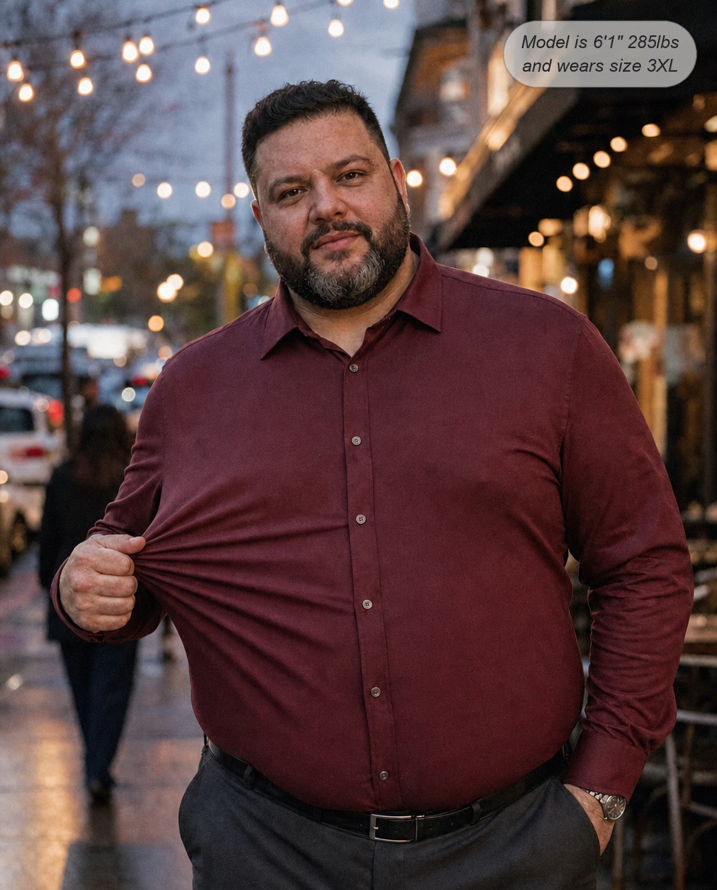 Sovereign stretch dress shirt in burgundy, long sleeve, stretching the fabric on an evening street
