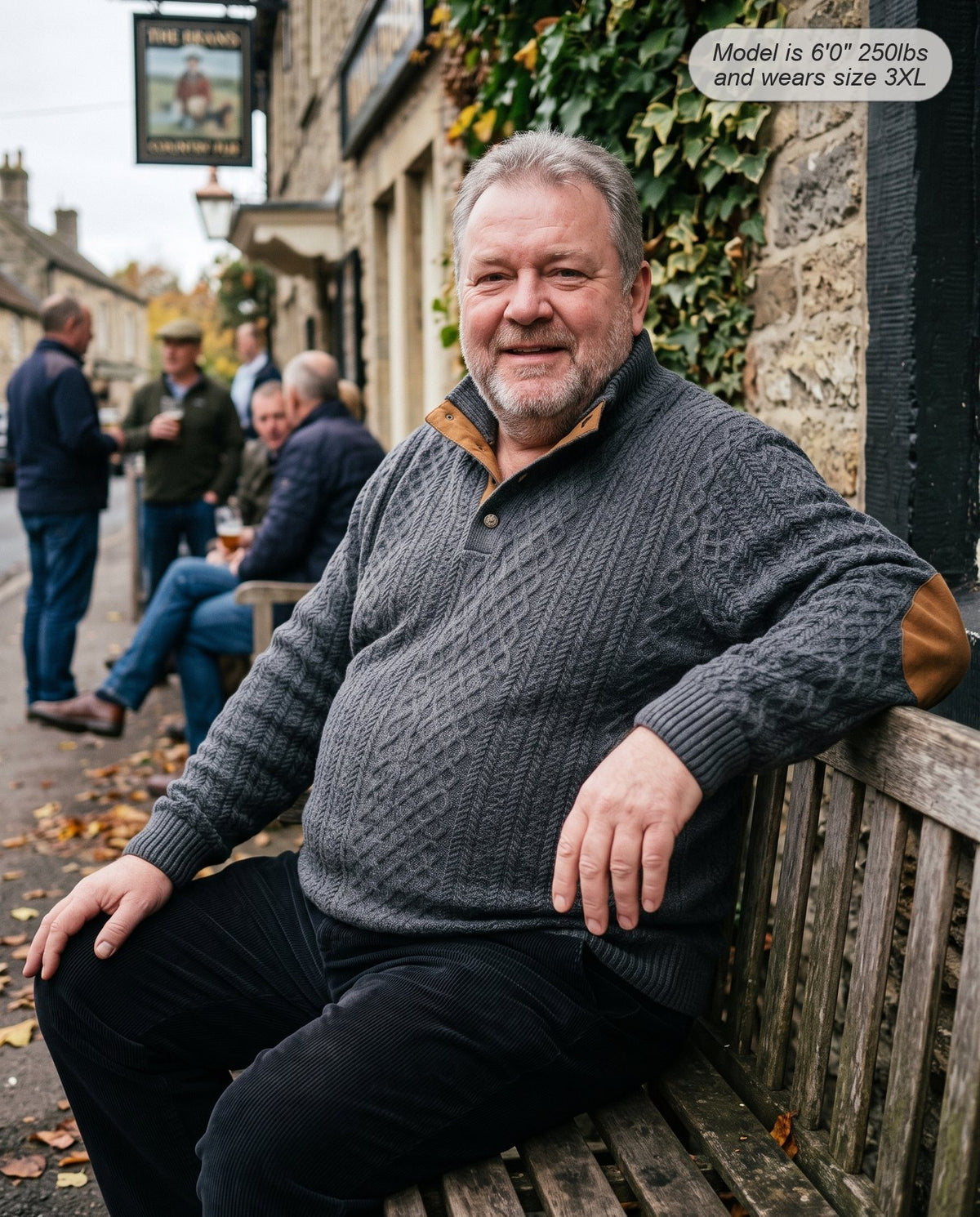 Man wearing the Bastion jacquard sweater in charcoal outside a country pub