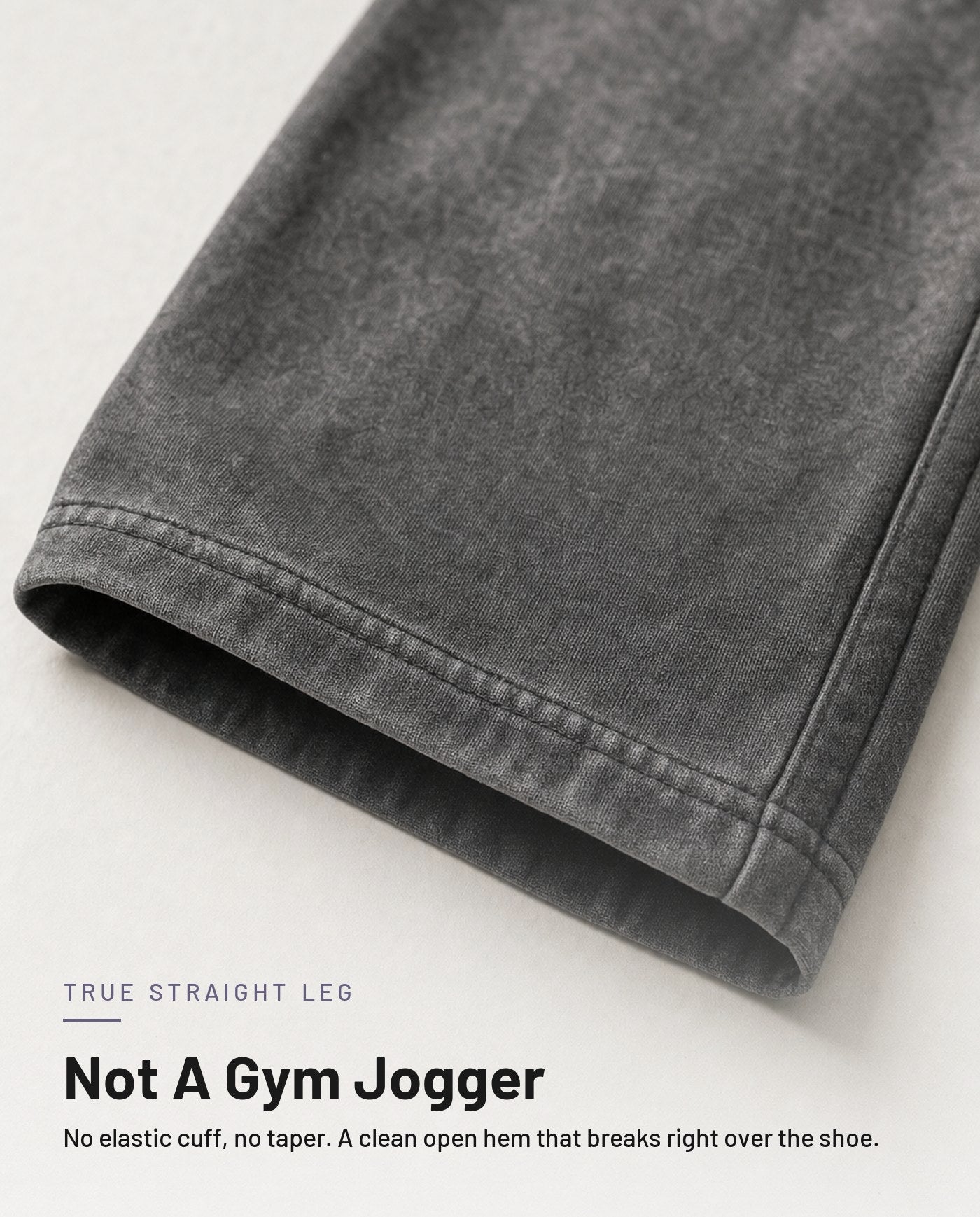 Open straight-leg hem detail in washed grey - no elastic cuff