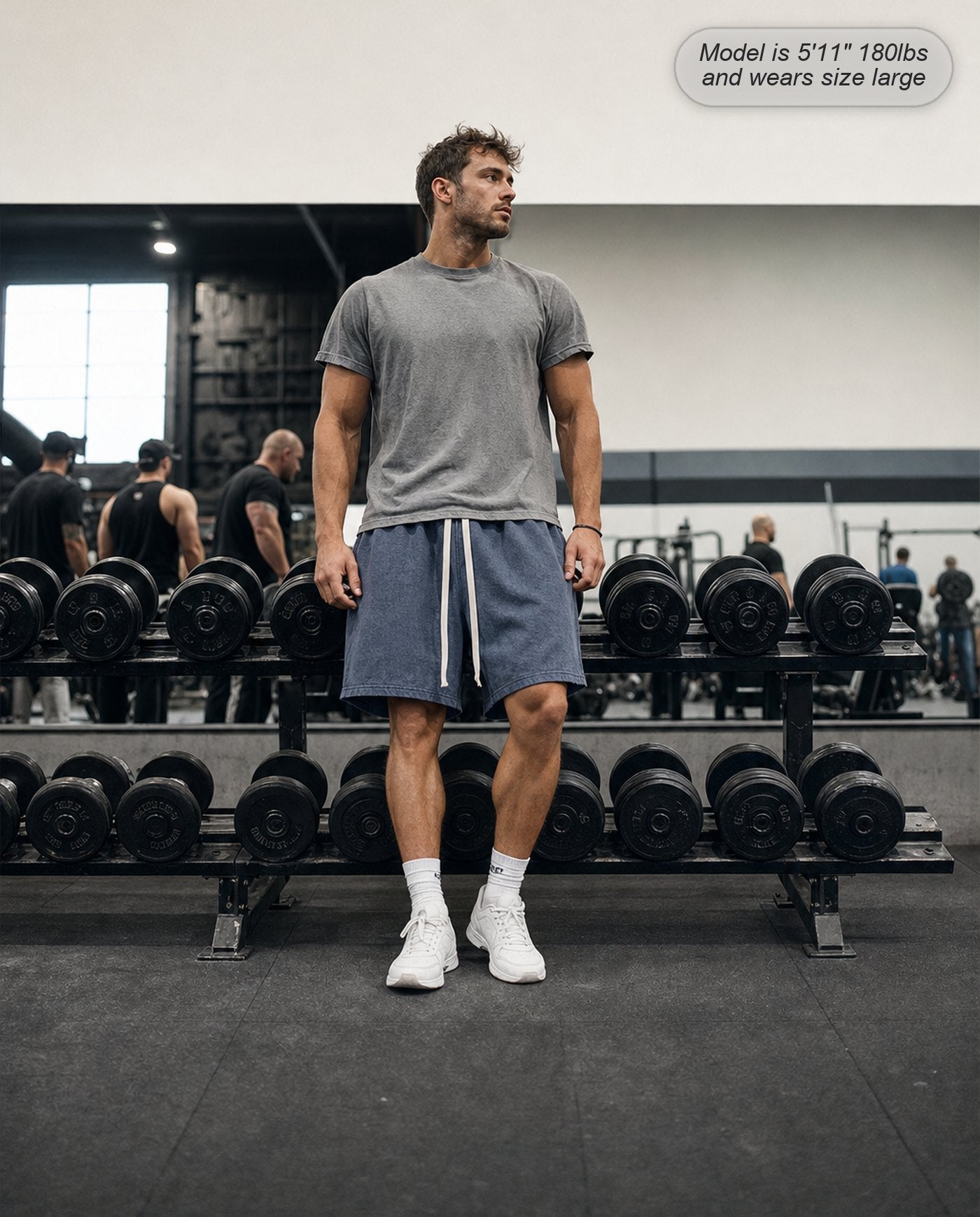 Man wearing Colossus shorts in washed navy at the gym