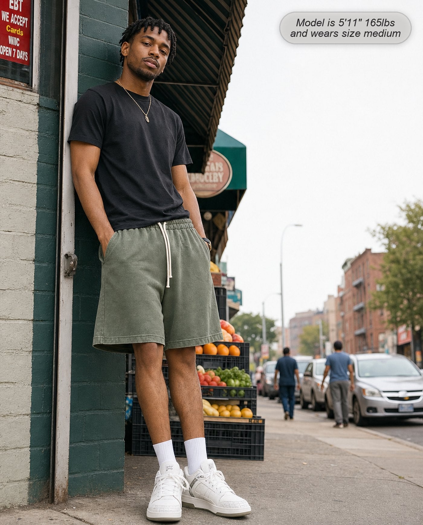 Man wearing Colossus shorts in washed army green on a city street
