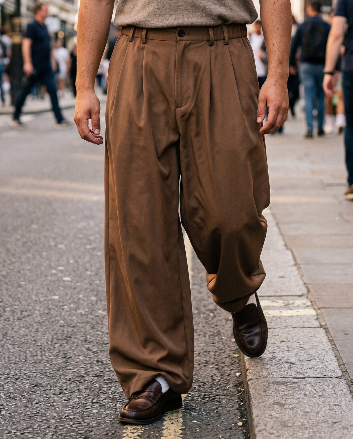 The Envoy trousers in coffee breaking over loafers at a kerb