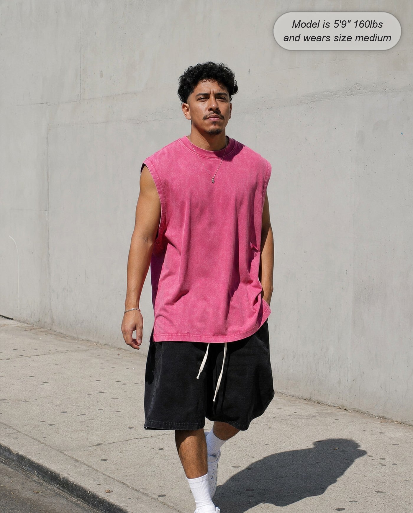 Man wearing the Ironclad acid wash tank in rose on the street