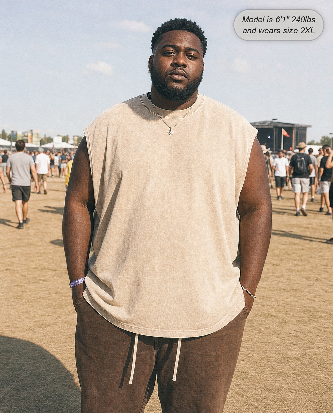 Man wearing the Ironclad acid wash tank in sand at a festival