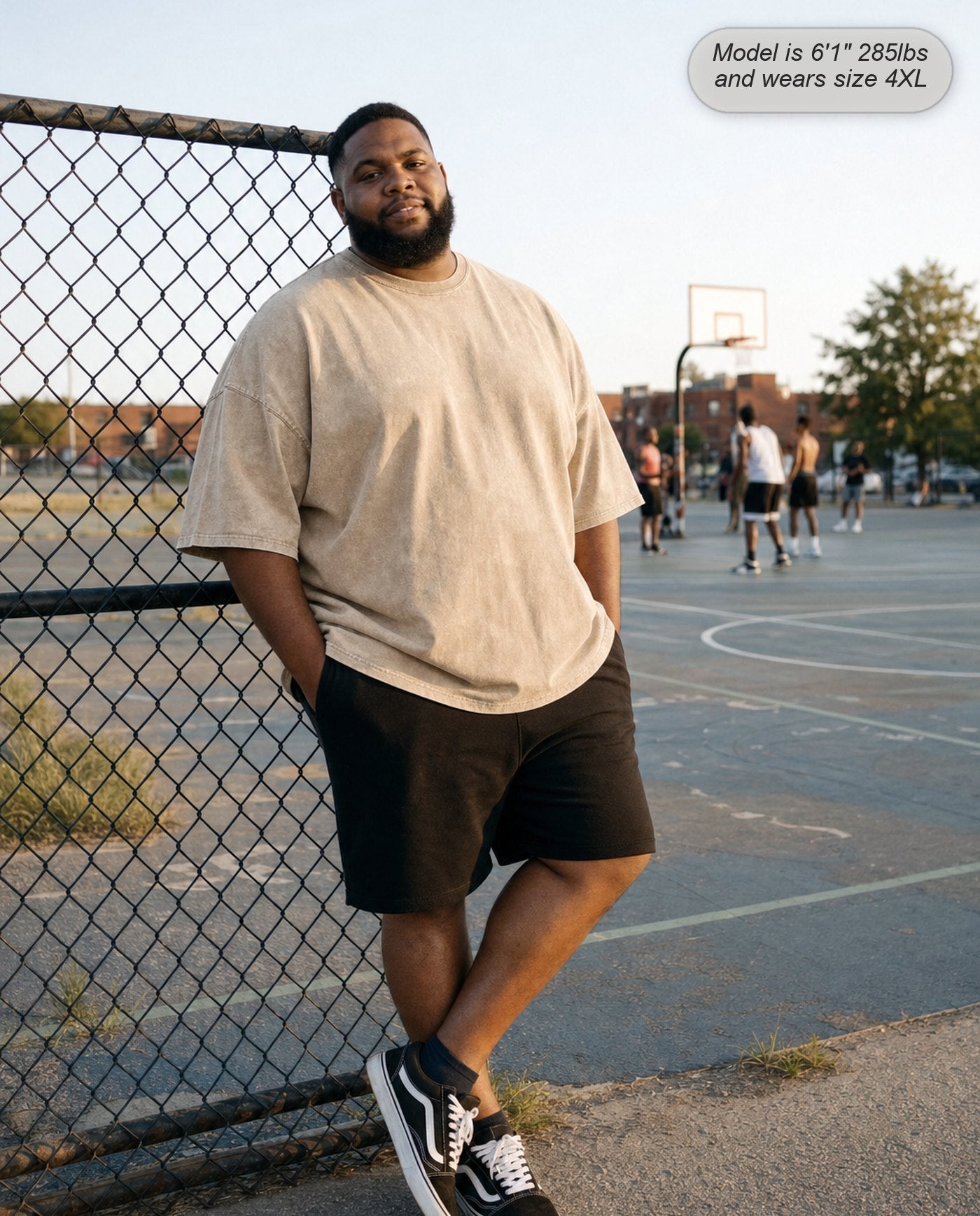 Man in a Vintage Cream Legion oversized acid wash tee at a basketball court