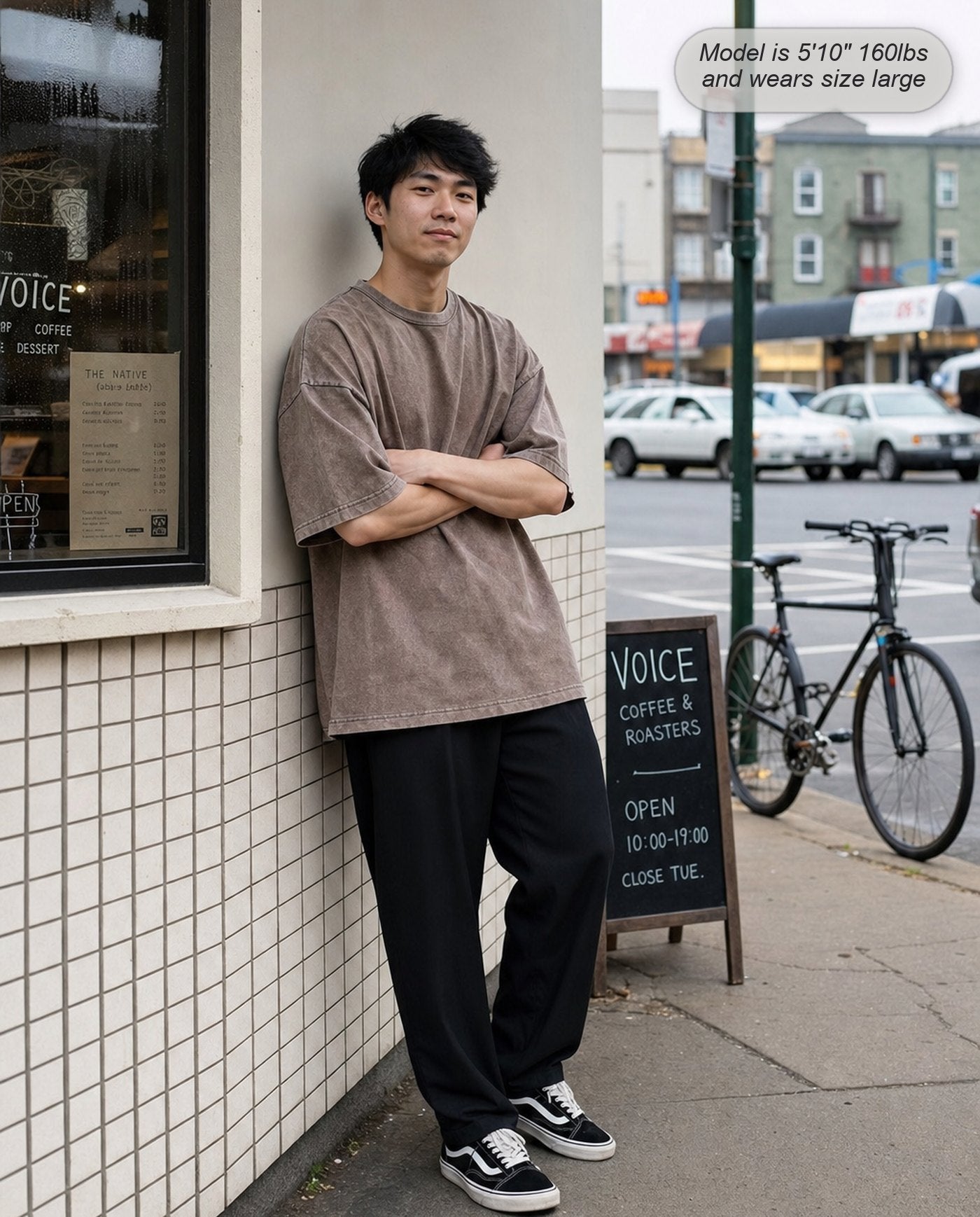 Man in a Mocha Legion oversized acid wash tee outside a coffee shop