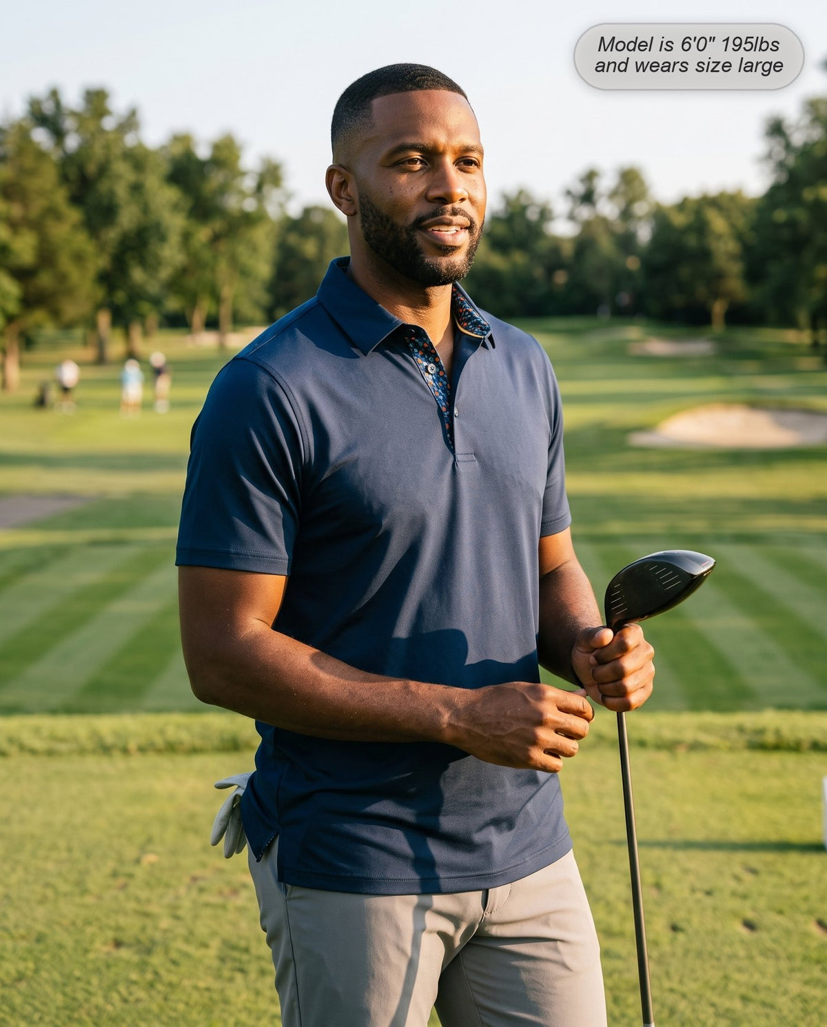Man wearing the Meridian golf polo in navy on the tee box