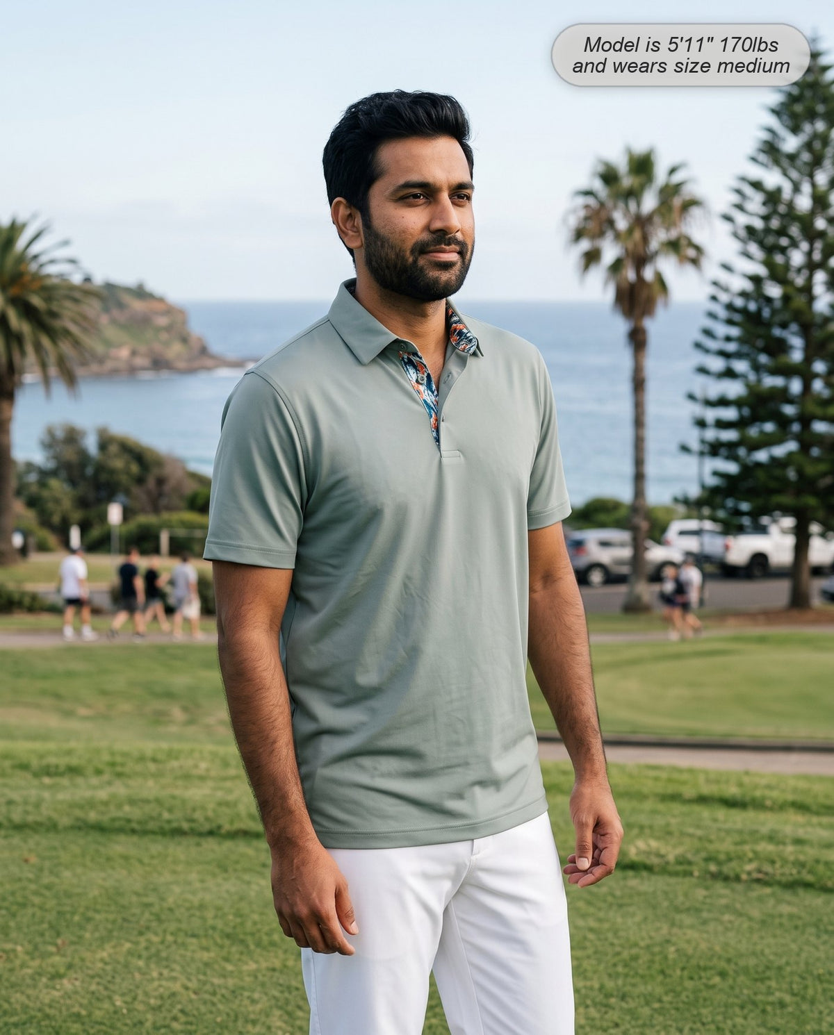 Man wearing the Meridian golf polo in sage on a coastal course