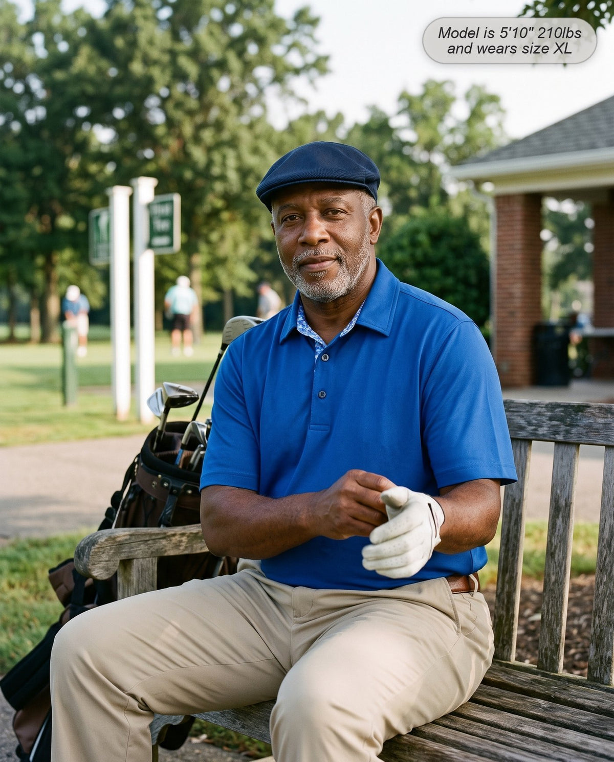 Man wearing the Meridian golf polo in cobalt blue on a bench at the first tee