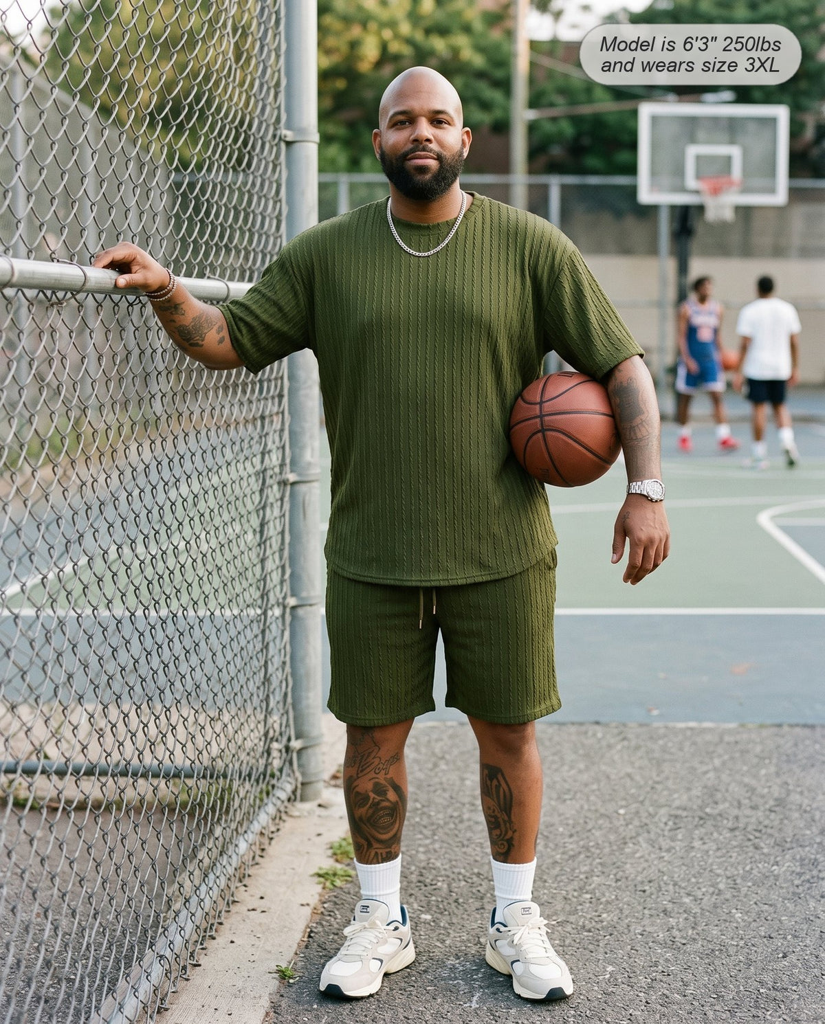 Man wearing the Monarch lounge short set in army green at a city basketball court