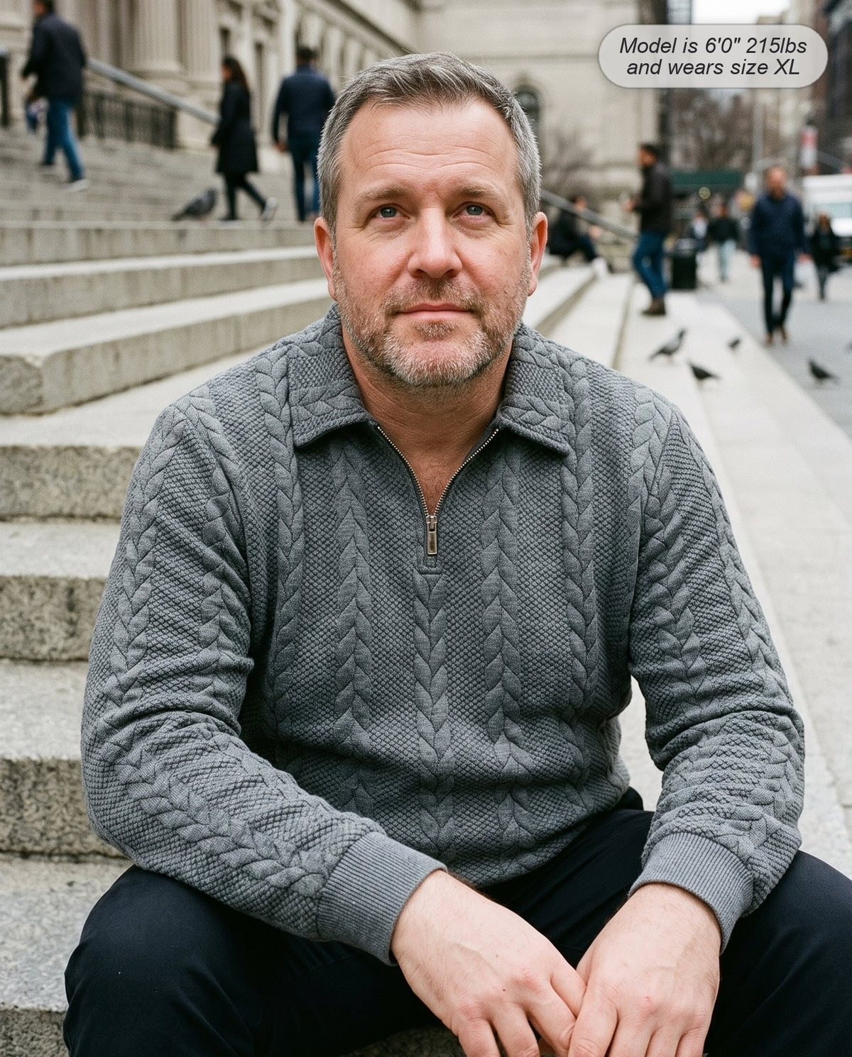Man wearing the Regent quarter zip knit in heather grey on museum steps