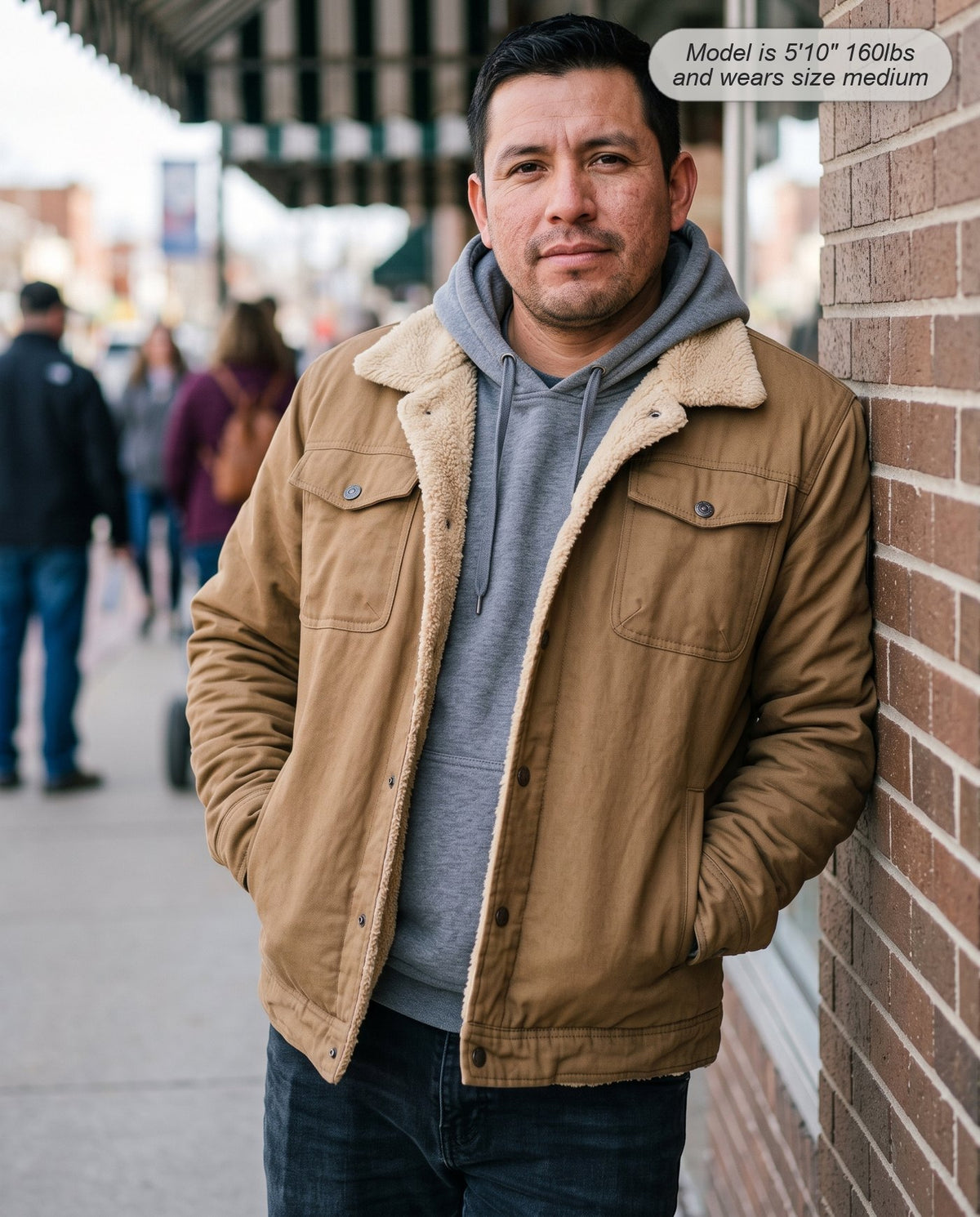 Man wearing the Sentinel sherpa jacket in camel on a small-town main street
