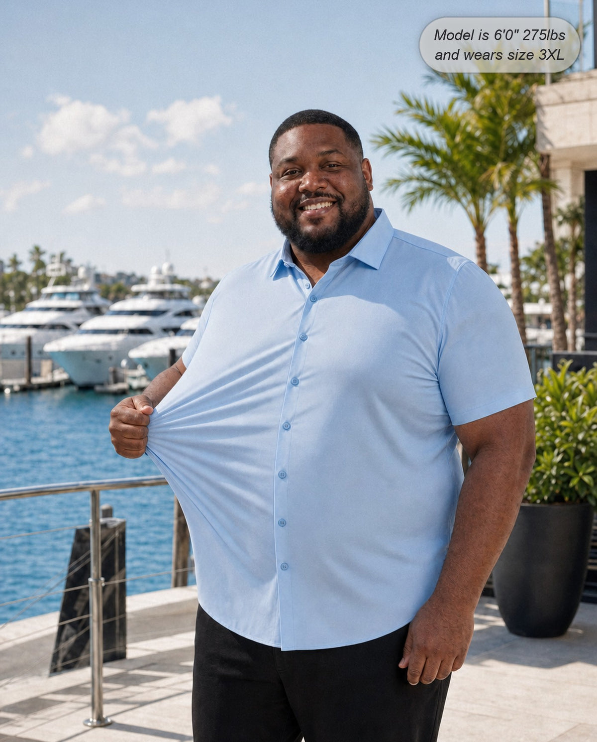 Sovereign stretch dress shirt in sky blue, short sleeve, stretching the fabric at a marina