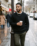 Man wearing the Admiral relaxed ribbed knit sweater in black on a city street