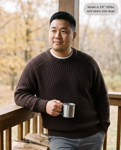 Man wearing the Admiral relaxed ribbed knit sweater in chocolate on a cabin porch