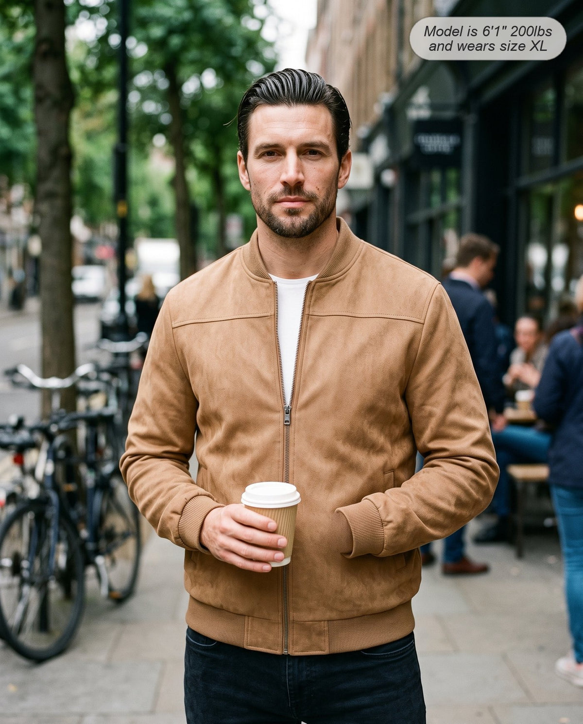 Man wearing the Atlas suede bomber jacket in camel on a city street