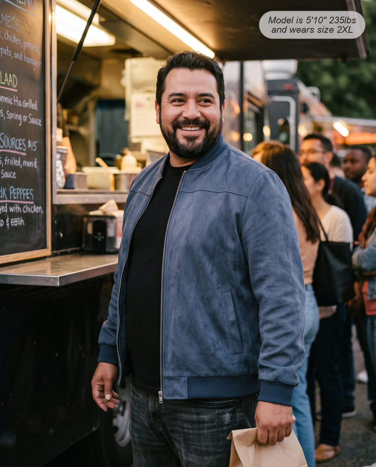 Man wearing the Atlas suede bomber jacket in slate navy at a food truck
