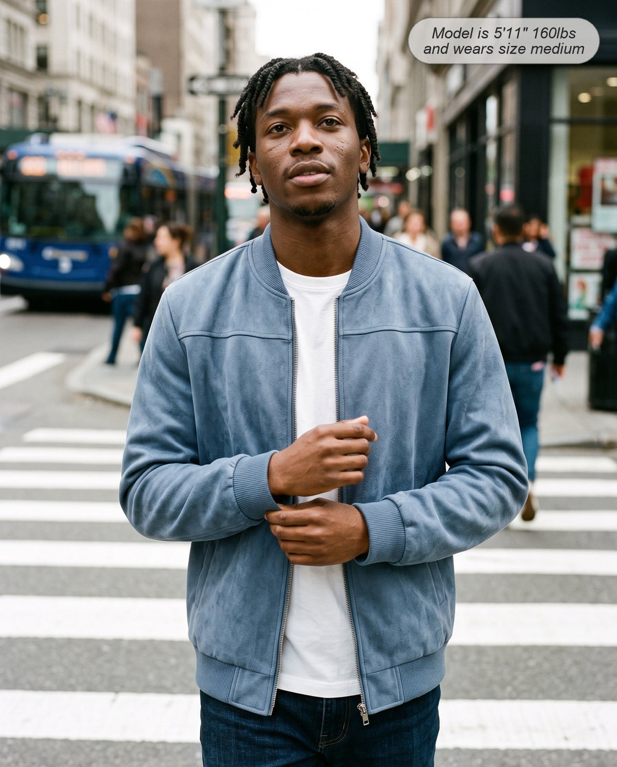 Man wearing the Atlas suede bomber jacket in steel blue crossing a street