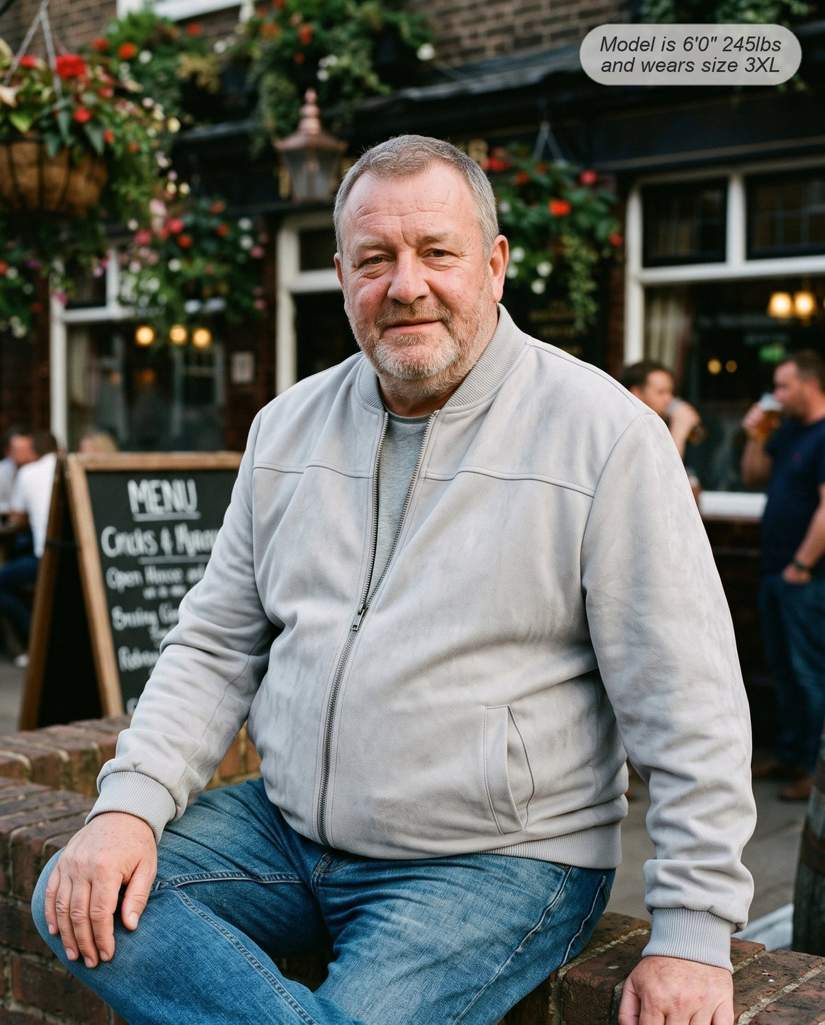 Man wearing the Atlas suede bomber jacket in light grey outside a pub