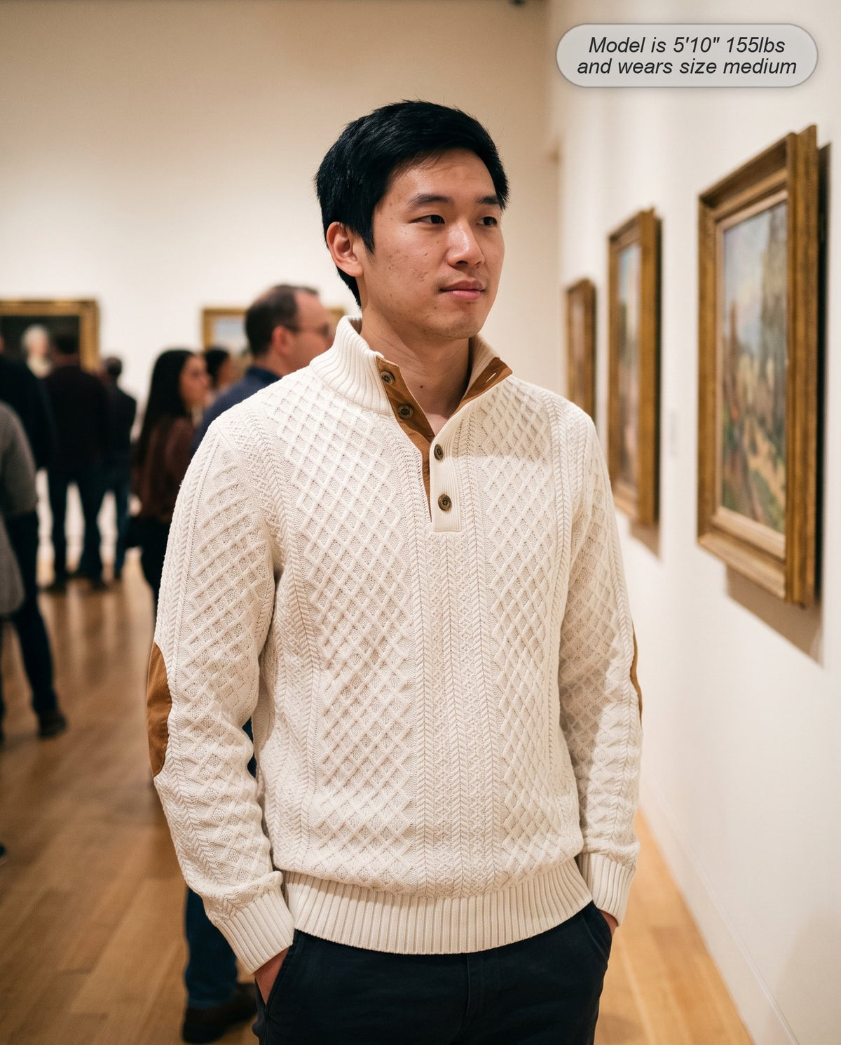 Man wearing the Bastion jacquard sweater in ivory in an art gallery