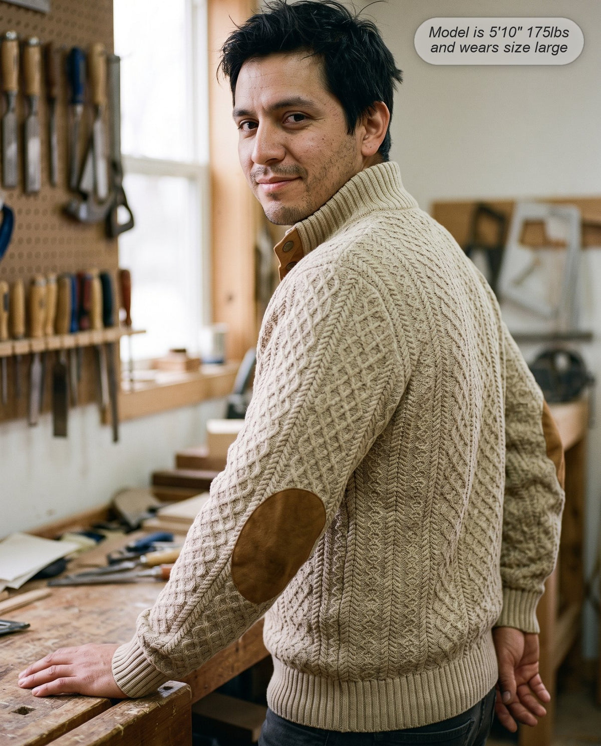Man wearing the Warden jacquard sweater in khaki in a workshop
