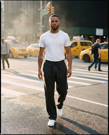 Man wearing the Citadel relaxed acid wash sweatpants in washed black at a city crosswalk
