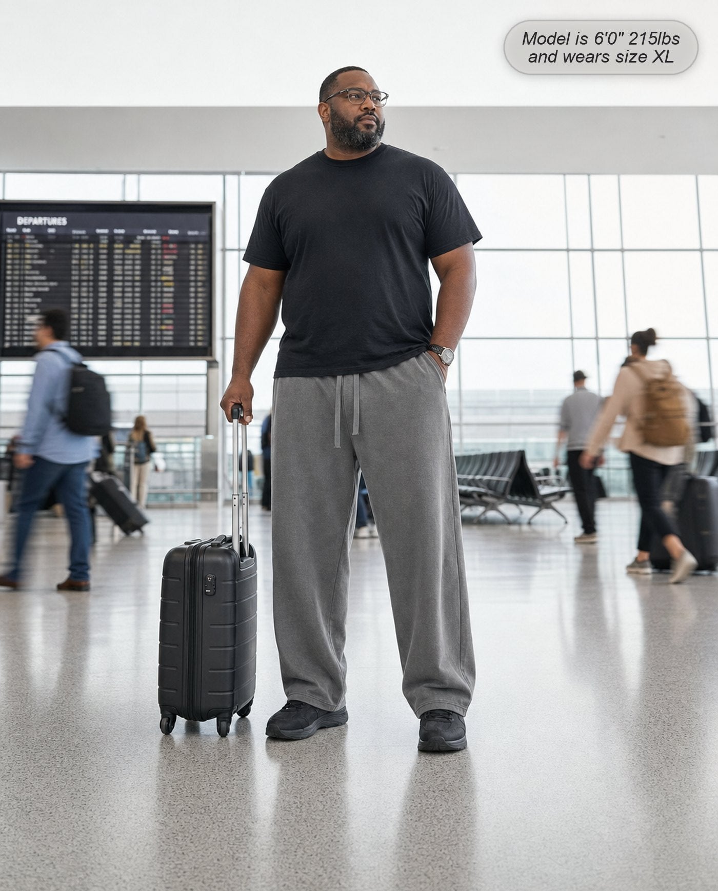 Man wearing Citadel sweatpants in washed grey at an airport terminal
