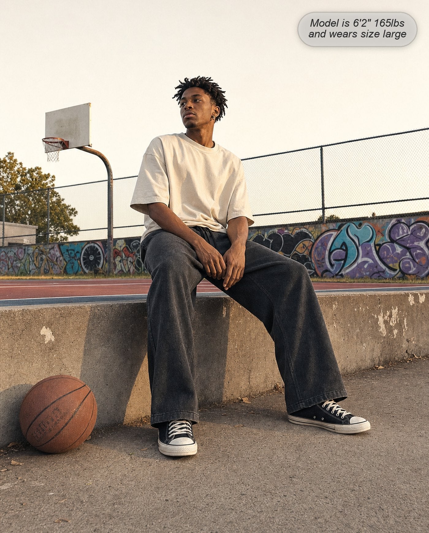 Man wearing Citadel sweatpants in washed black at a basketball court