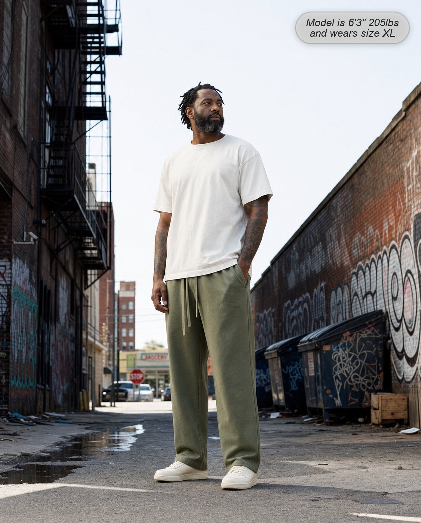 Man wearing Citadel sweatpants in washed army green in a city alley
