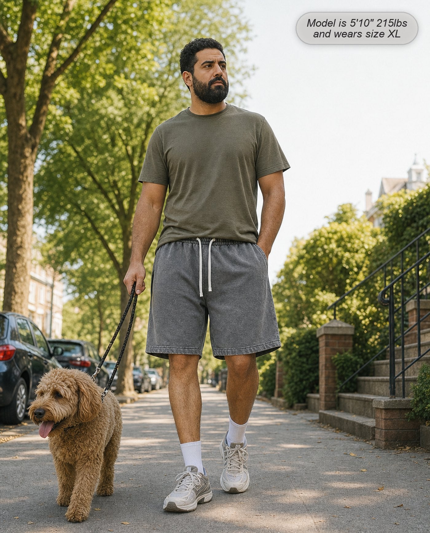 Man wearing Colossus shorts in stone grey walking a dog