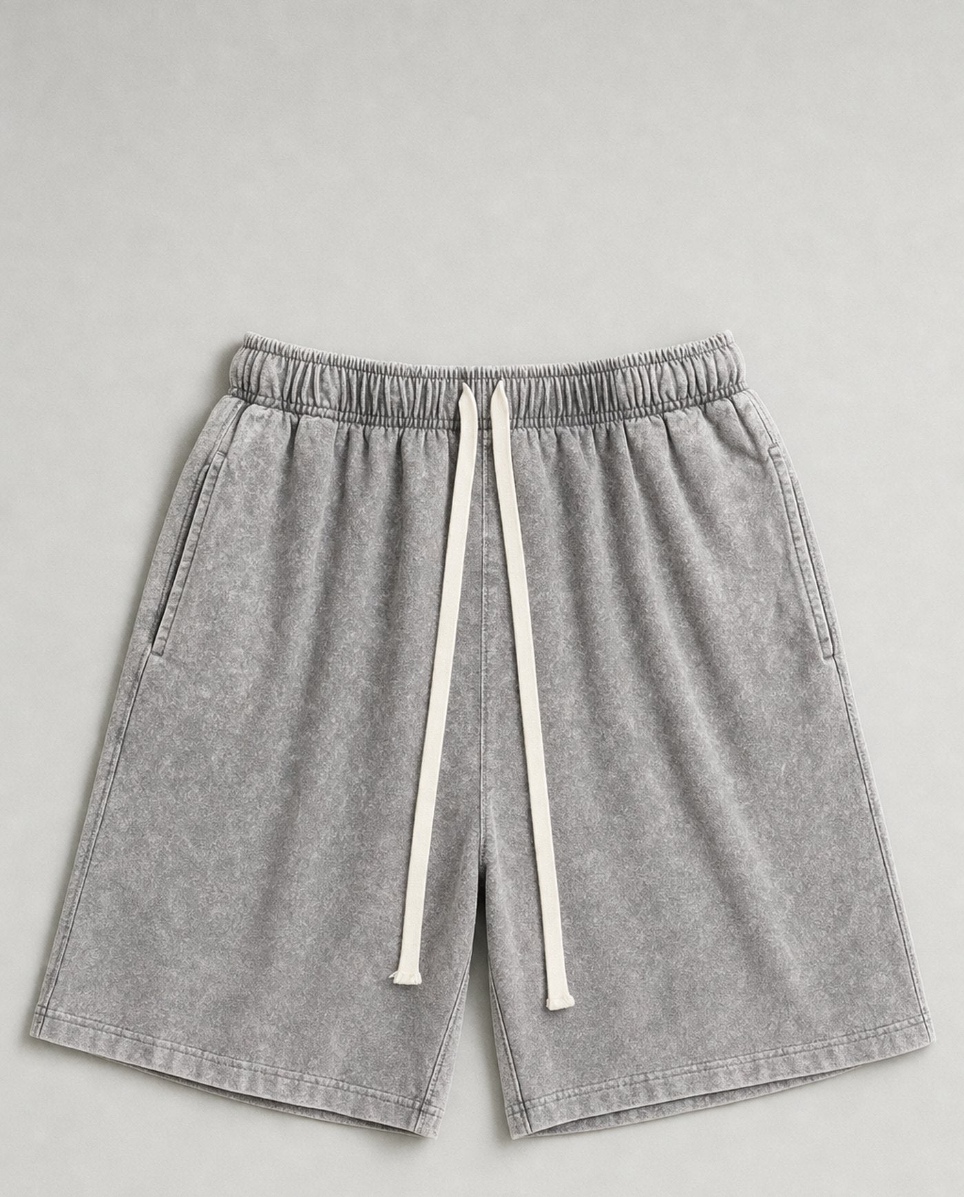 Colossus baggy acid wash shorts laid flat in stone grey
