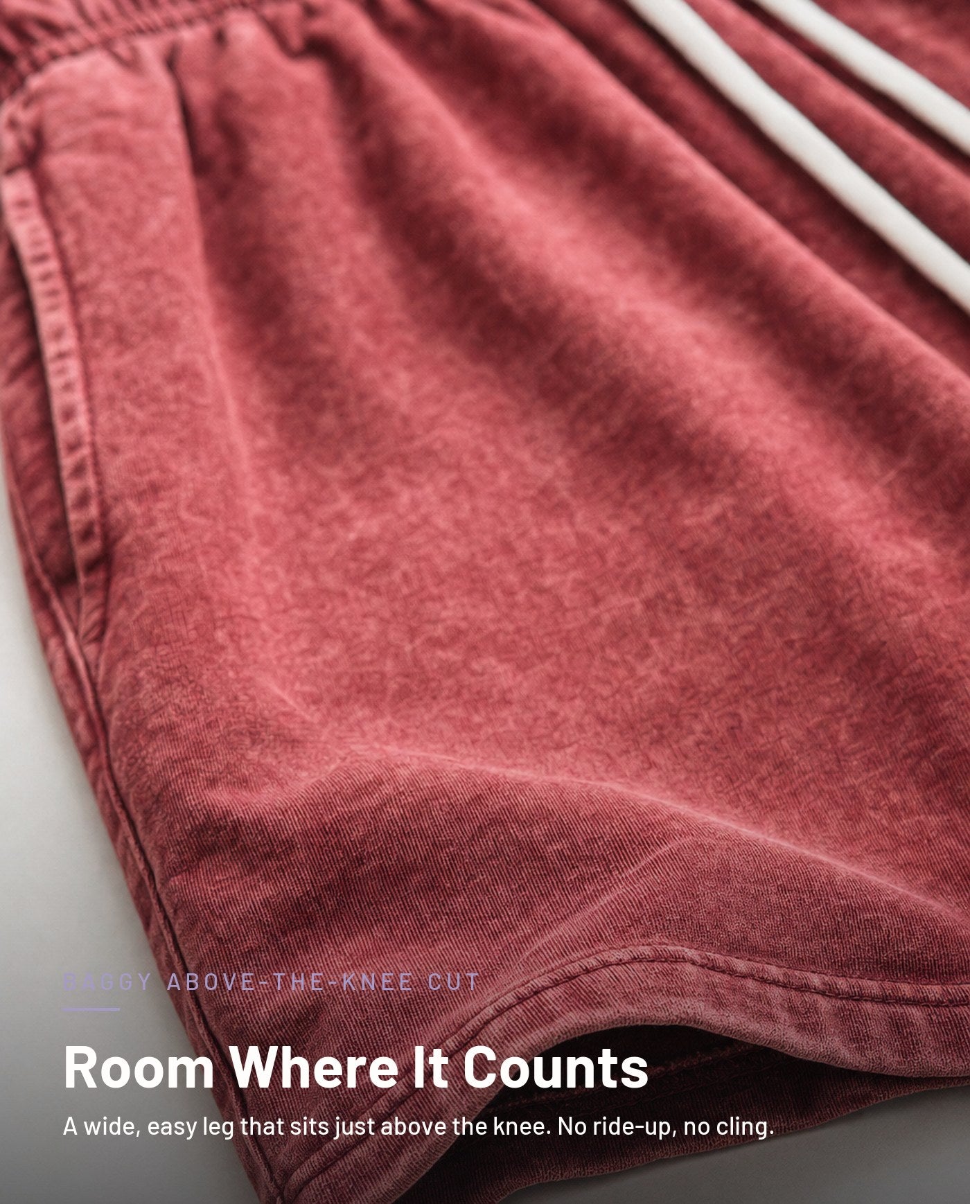 Baggy above-the-knee leg opening detail in washed red