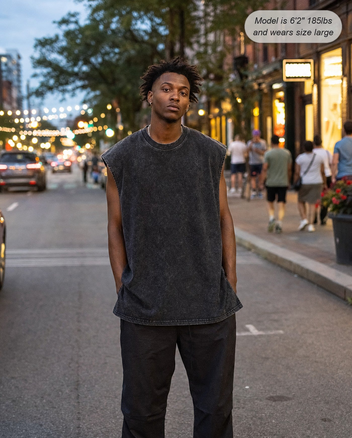 Man wearing the Ironclad oversized acid wash tank in black on the street
