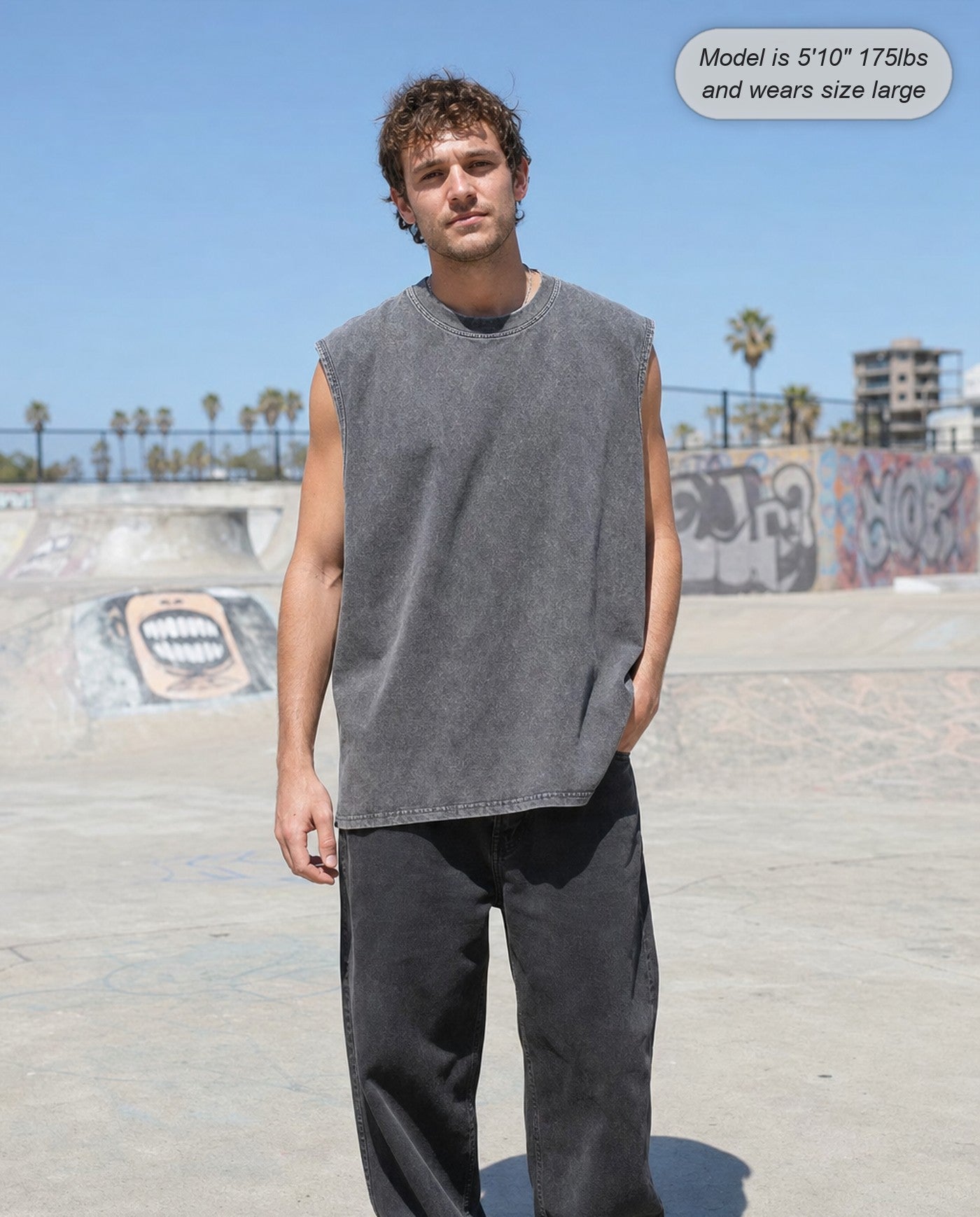 Man wearing the Ironclad acid wash tank in gray at a skatepark