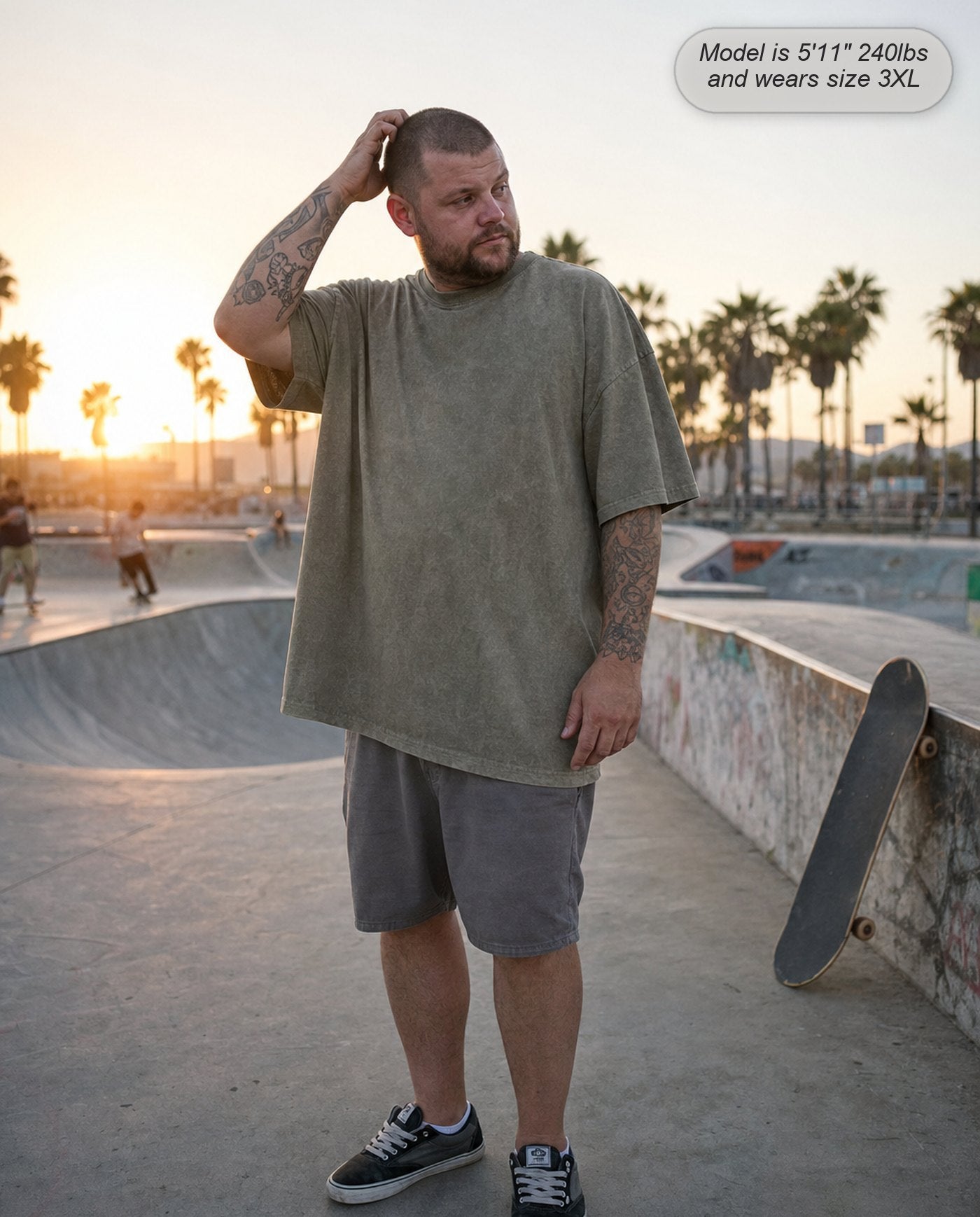 Man in an Army Green Legion oversized acid wash tee at a skatepark