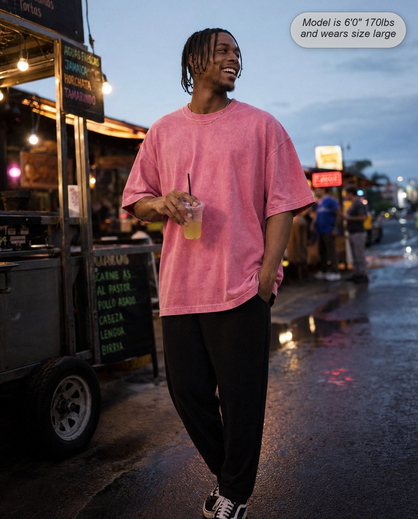 Man in a Rose Pink Legion oversized acid wash tee at a street food cart