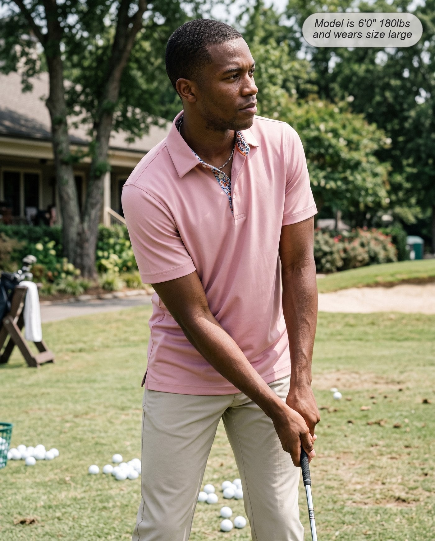 Man wearing the Meridian golf polo in dusty pink chipping at the practice area
