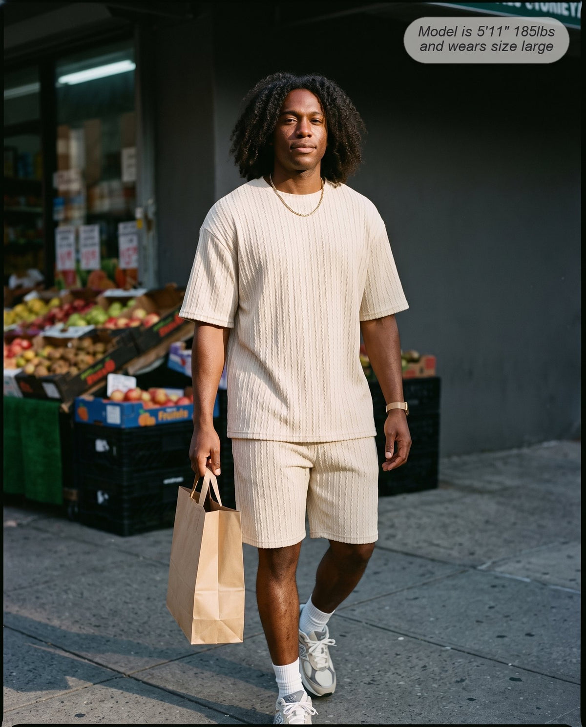 Man wearing the Monarch lounge short set in sand outside a corner grocery
