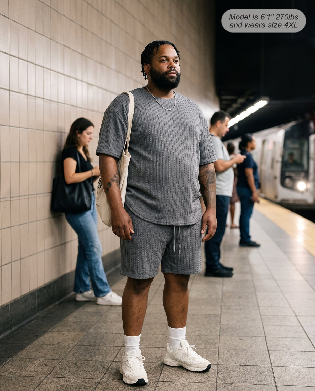 Man wearing the Monarch lounge short set in charcoal on a subway platform
