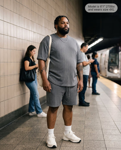 Man wearing the Monarch lounge short set in charcoal on a subway platform