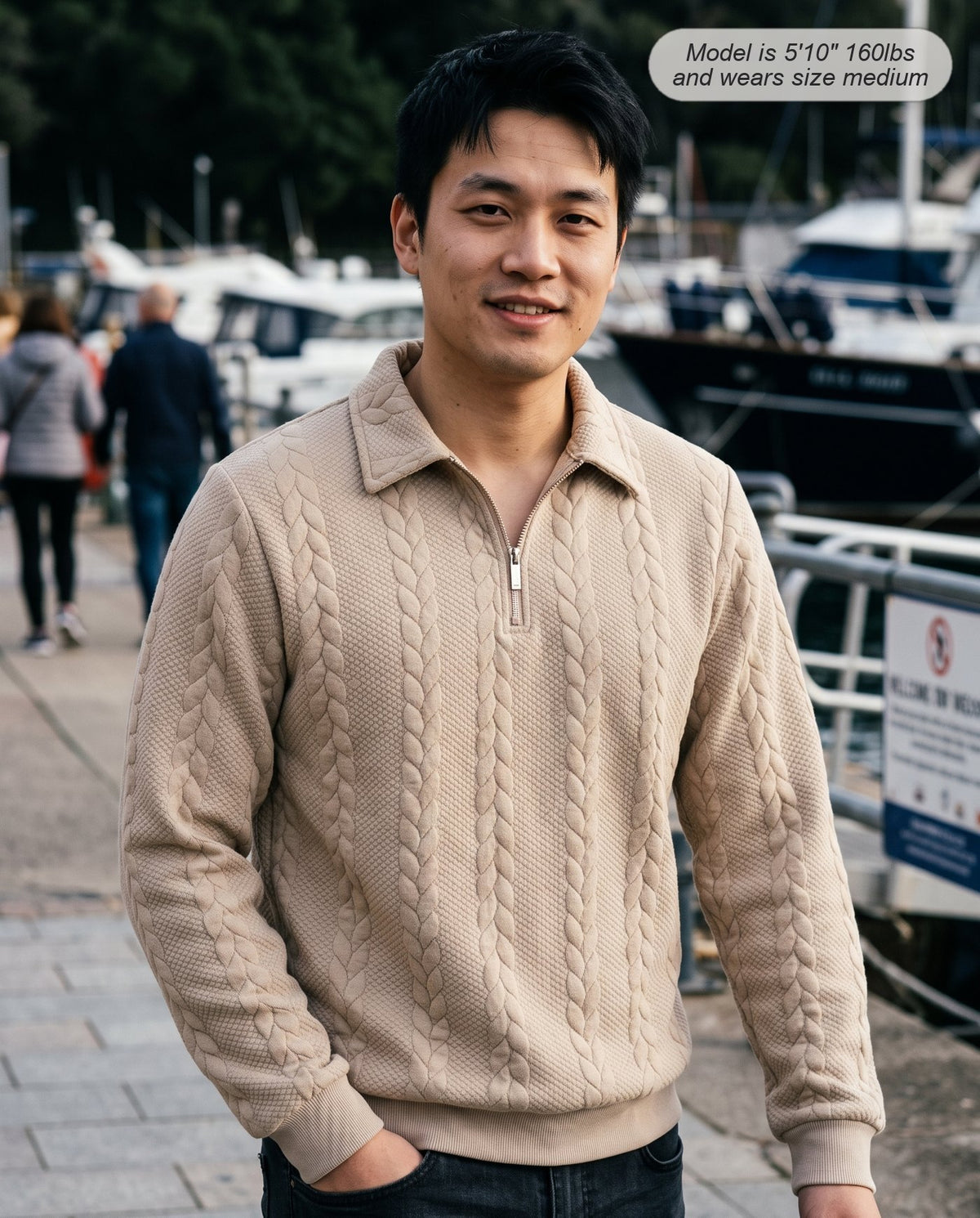 Man wearing the Regent quarter zip knit in khaki on a harbour promenade