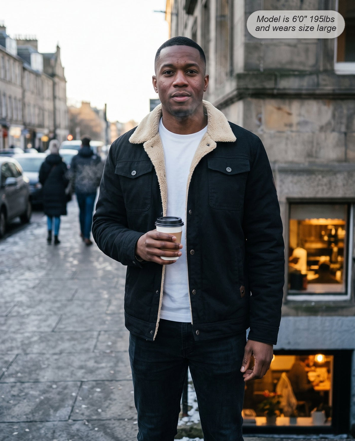 Man wearing the Sentinel sherpa jacket in black on a cold city street